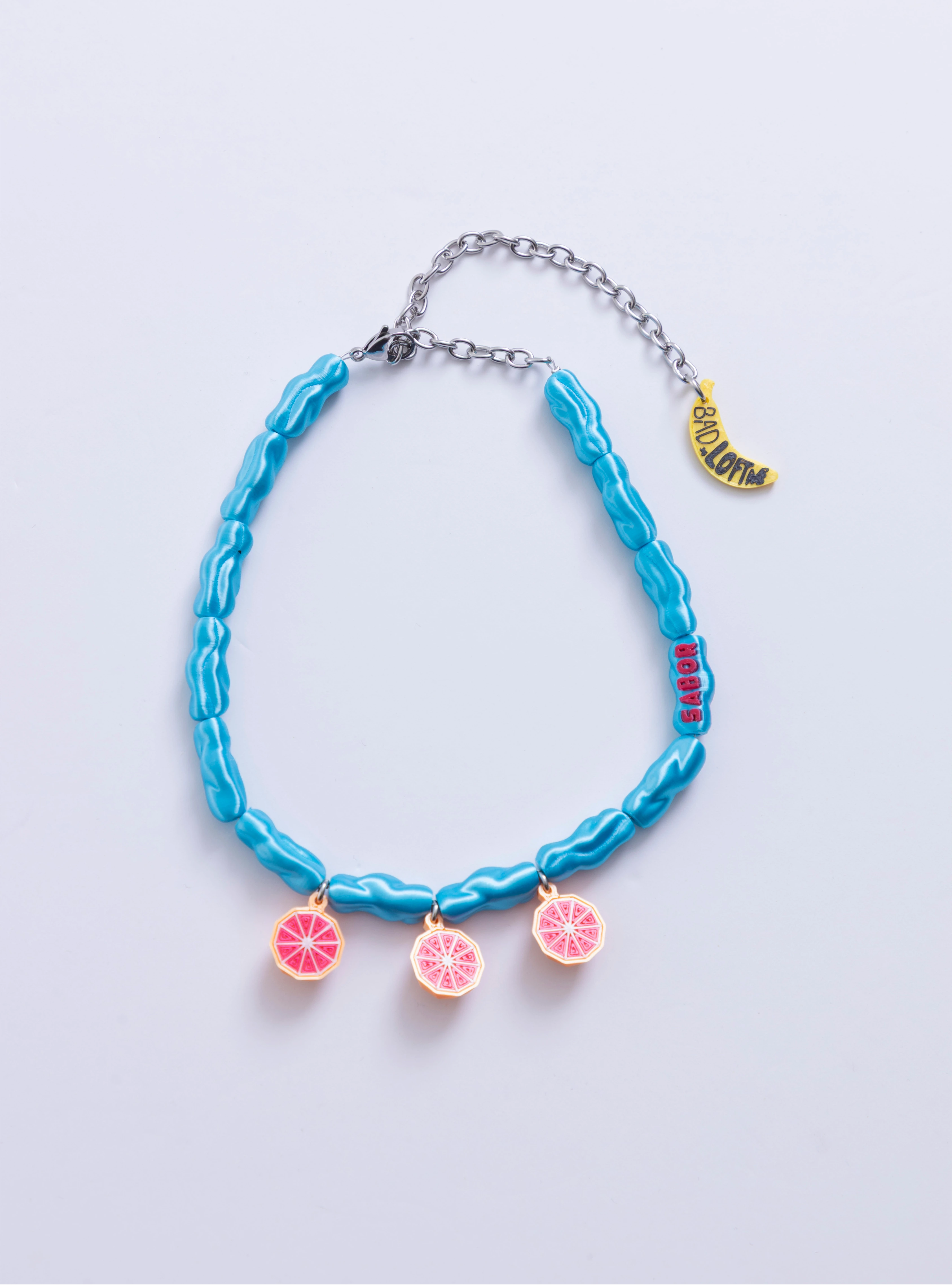 Collar Alto en sabor Loft Me en eslabones azules con toronjas 3D.

Collar de impresión 3D Alto en sabor con dije rojo Alto en Sabor.

Collar colaborativo Loft Me x Bad Influencer en azul eléctrico y frutas.